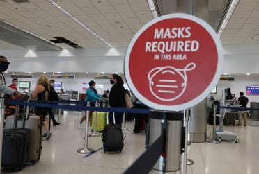  A sign reading, 'masks required in this area,' is seen at the Miami International Airport on February 01, 2021 in Miami, Florida. (AFP)
