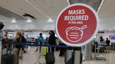  A sign reading, 'masks required in this area,' is seen at the Miami International Airport on February 01, 2021 in Miami, Florida. (AFP)