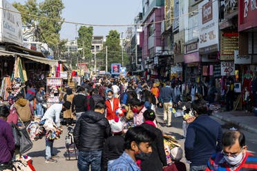 Shoppers gather at a market area in New Delhi on December 19, 2020. (AFP)