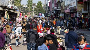 Shoppers gather at a market area in New Delhi on December 19, 2020, as India surged past 10 million coronavirus cases. (AFP)