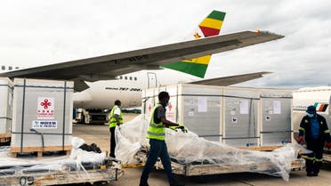 Workers offload part of a consignment of 200,000 doses of the Sinopharm coronavirus vaccine from China off an Air Zimbabwe aeroplane which has just landed on February 15, 2021 at the Robert Mugabe International Airport. (AFP)