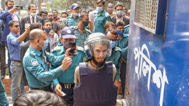 Mozammel Hossain, wearing bullet proof jacket and helmet, one among those convicted in the 2015 killing of Bangladeshi-American blogger Avijit Roy, is brought to the Anti-Terrorism Special Tribunal in Dhaka, Bangladesh, February 16, 2021. (AP/Mahmud Hossain Opu)