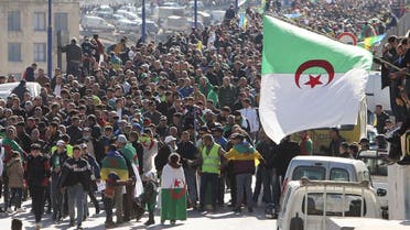 Demonstrators carry national flags as they gather in the town of Kherrata, marking two years since the start of a mass protest movement there demanding political change, Algeria February 16, 2021. (Reuters/Ramzi Boudina)