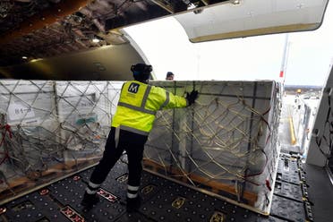 A box containing vaccines is unloaded from a Hungarian Airbus 330 cargo plane as the first batch of the vaccine against the new coronavirus produced by Sinopharm of China arrives at Budapest Liszt Ferenc International Airport in Budapest, Hungary, Tuesday, February 16, 2021. (AP)