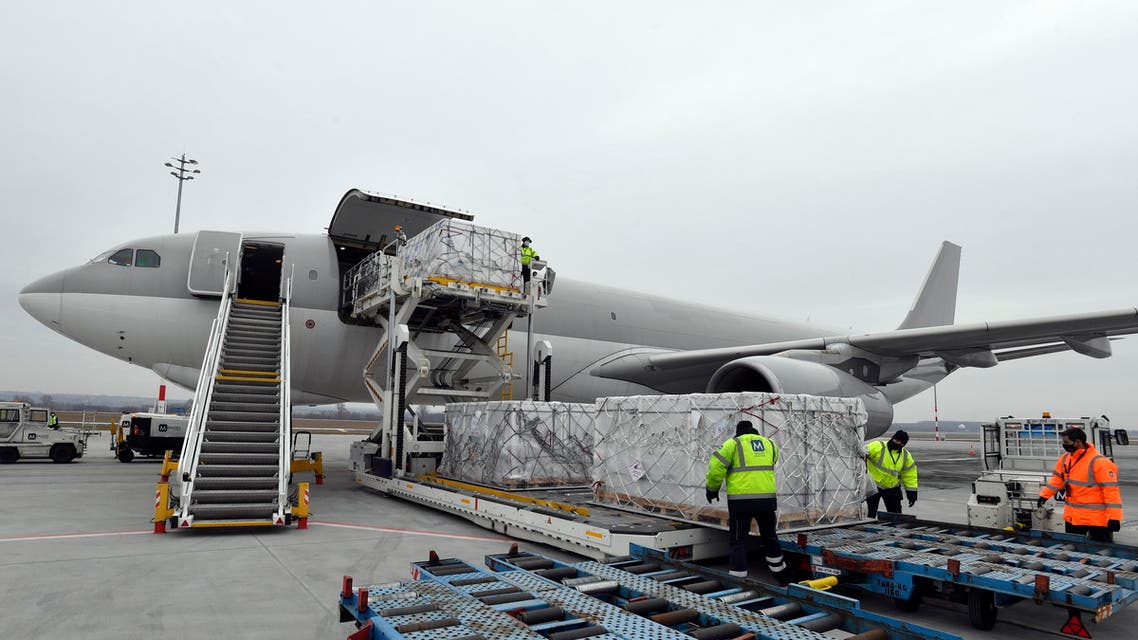 Boxes containing vaccines are unloaded from a Hungarian Airbus 330 cargo plane as the first batch of the vaccine against the new coronavirus produced by Sinopharm of China arrives at Budapest Liszt Ferenc International Airport in Budapest, Hungary, Tuesday, Feb. 16, 2021. (AP)