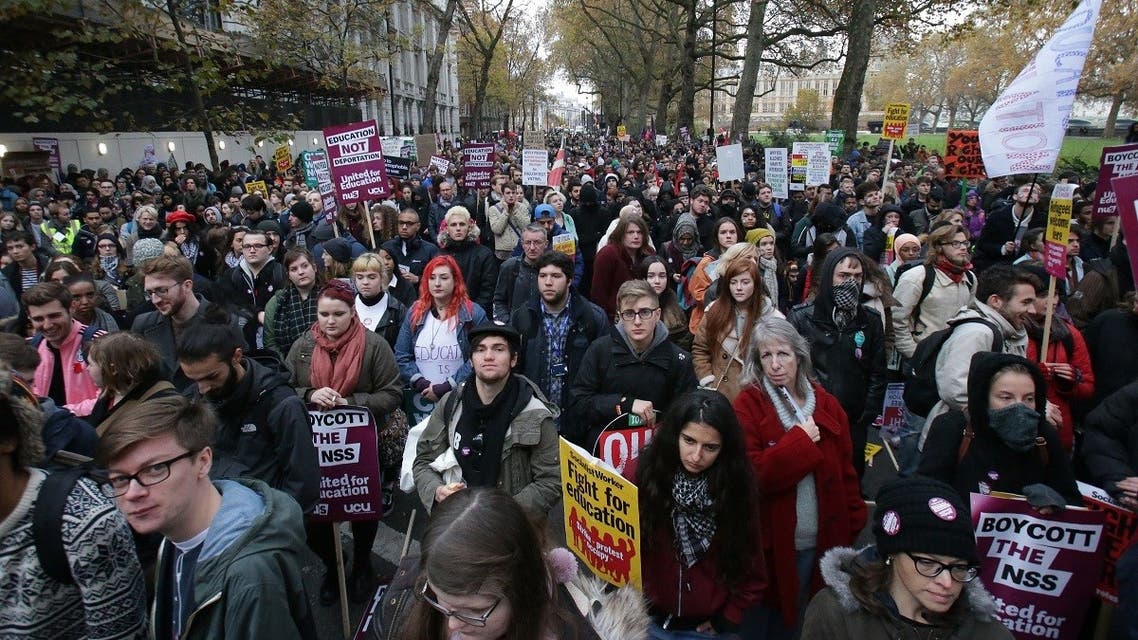 Demonstrators hold up placards at a protest march through central London on November 19, 2016 called by the National Union of Students and University College Union to demand free, quality further and higher education, accessible to all. (Daniel Leal-Olivas/AFP)
