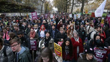 Demonstrators hold up placards at a protest march through central London on November 19, 2016 called by the National Union of Students and University College Union to demand free, quality further and higher education, accessible to all. (Daniel Leal-Olivas/AFP)