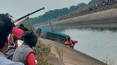A bus that fell into a canal is pulled out in Sidhi district, in the central Indian state of Madhya Pradesh, Tuesday, Feb. 16, 2021. (Madhya Pradesh District Public Relation Office Sidhi via AP)