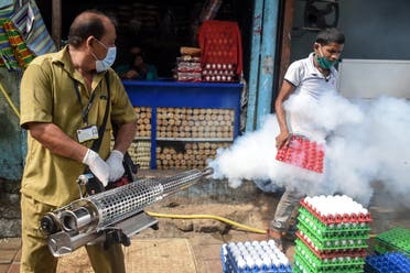 A civic worker fumigates a slum area as a preventive measure against malaria and dengue ahead of monsoon in Mumbai on June 12, 2020. (File photo: AFP)
