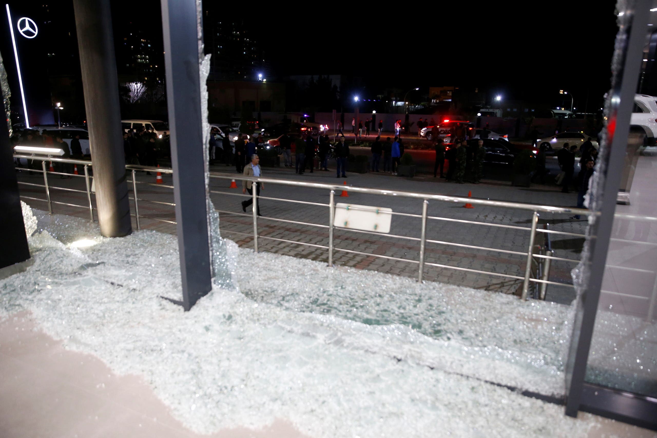 Broken glass is seen at the Bright Castle Motors building after reports of mortar shells landing near Erbil airport, in Erbil, Iraq. (Reuters)