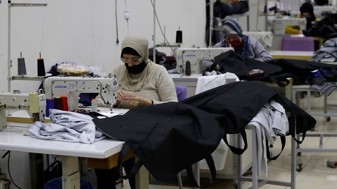 Seamstresses sew body bags for COVID-19 victims at al-Oum institution sewing factory in Saida south of Beirut on February 16, 2021. (Joseph Eid/AFP)