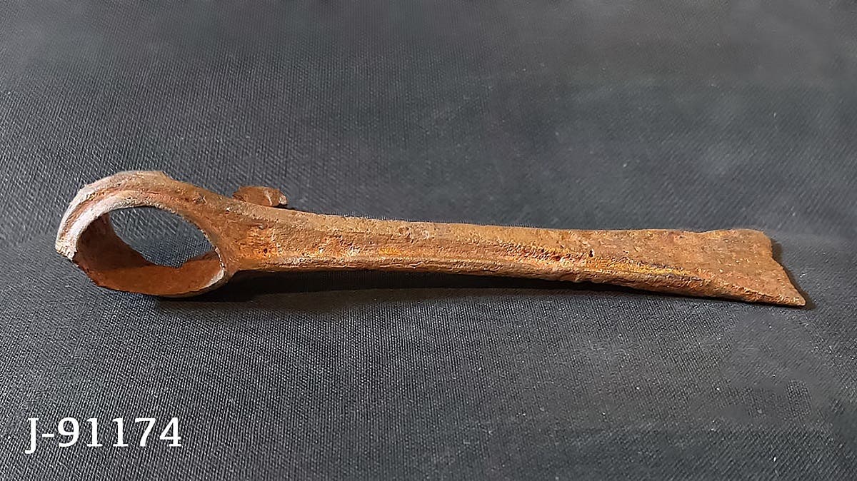 A handout picture released on February 17, 2021 shows a view of an axe-head reportedly belonging to the enemy found with the mummy of ancient Egyptian King Seqenenre-Taa-II. (Egyptian Ministry of Antiquities/AFP)