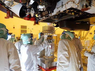 This NASA photo obtained July 20, 2020 shows an image taken on May 20, 2020 at the Kennedy Space Center, Florida as engineers and technicians insert 39 sample tubes into the belly of the Mars rover. NASA's Perseverance rover mission will collect the first samples from another planet for return to Earth. (AFP)
