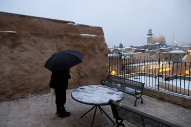 A Jewish man prays in Jerusalem's Old city on a snowy morning in the city, February 18, 2021. (Reuters)
