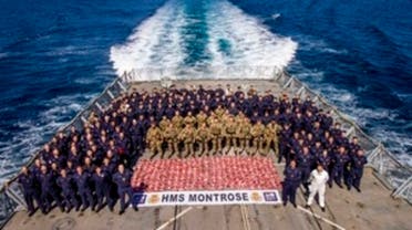 Royal Marines and sailors stand around the confiscated 2.4 tons of drugs. (File photo: UK MoD Crown)