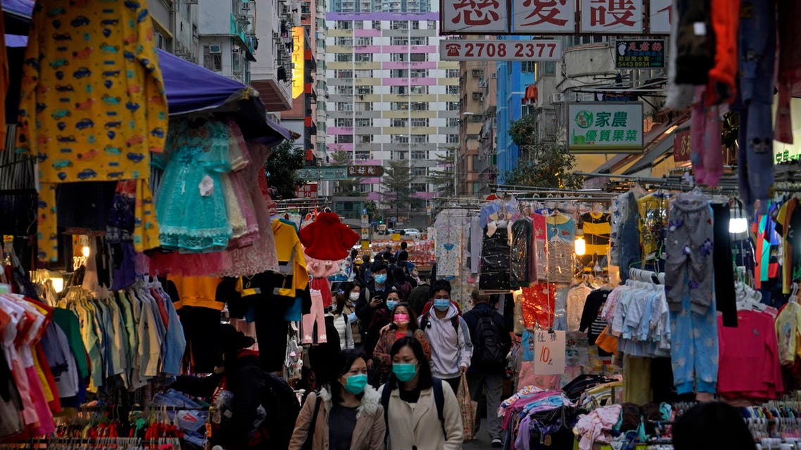 People wearing face masks to protect against the spread of the coronavirus, walks at a market in Hong Kong, Wednesday, Jan. 20, 2021. (AP)