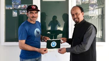 Pakistani mountaineer Mohammad Ali Sadpara (L) poses for a photo with a member of Alpine Club of Pakistan in Islamabad, Pakistan, in this undated photograph. (Reuters)