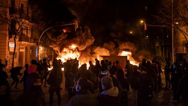 Demonstrators gather near a burning barricade during clashes with police following a protest condemning the arrest of rap singer Pablo Hasél in Barcelona, Spain, on February 18, 2021. (AP)