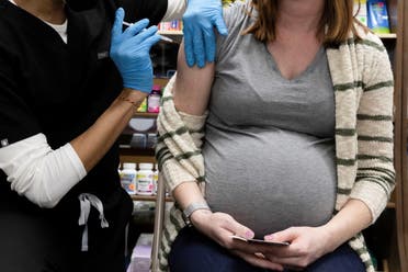 A pregnant woman receives a vaccine for the coronavirus disease (COVID-19) at Skippack Pharmacy in Schwenksville, Pennsylvania, U.S., February 11, 2021. (Reuters)