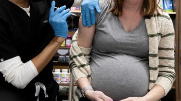A pregnant woman receives a vaccine for the coronavirus disease (COVID-19) at Skippack Pharmacy in Schwenksville, Pennsylvania, U.S., February 11, 2021. (Reuters)