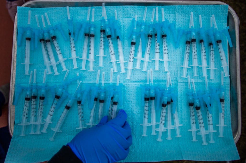 A nurse takes a Moderna Covid-19 vaccines ready to be administered in South Central Los Angeles, California on February 16, 2021. (AFP)