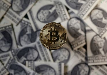 A bitcoin (virtual currency) coin placed on Dollar banknotes is seen in this illustration picture, November 6, 2017. (File photo: Reuters)