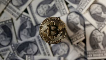 A bitcoin (virtual currency) coin placed on Dollar banknotes is seen in this illustration picture, November 6, 2017. (File photo: Reuters)