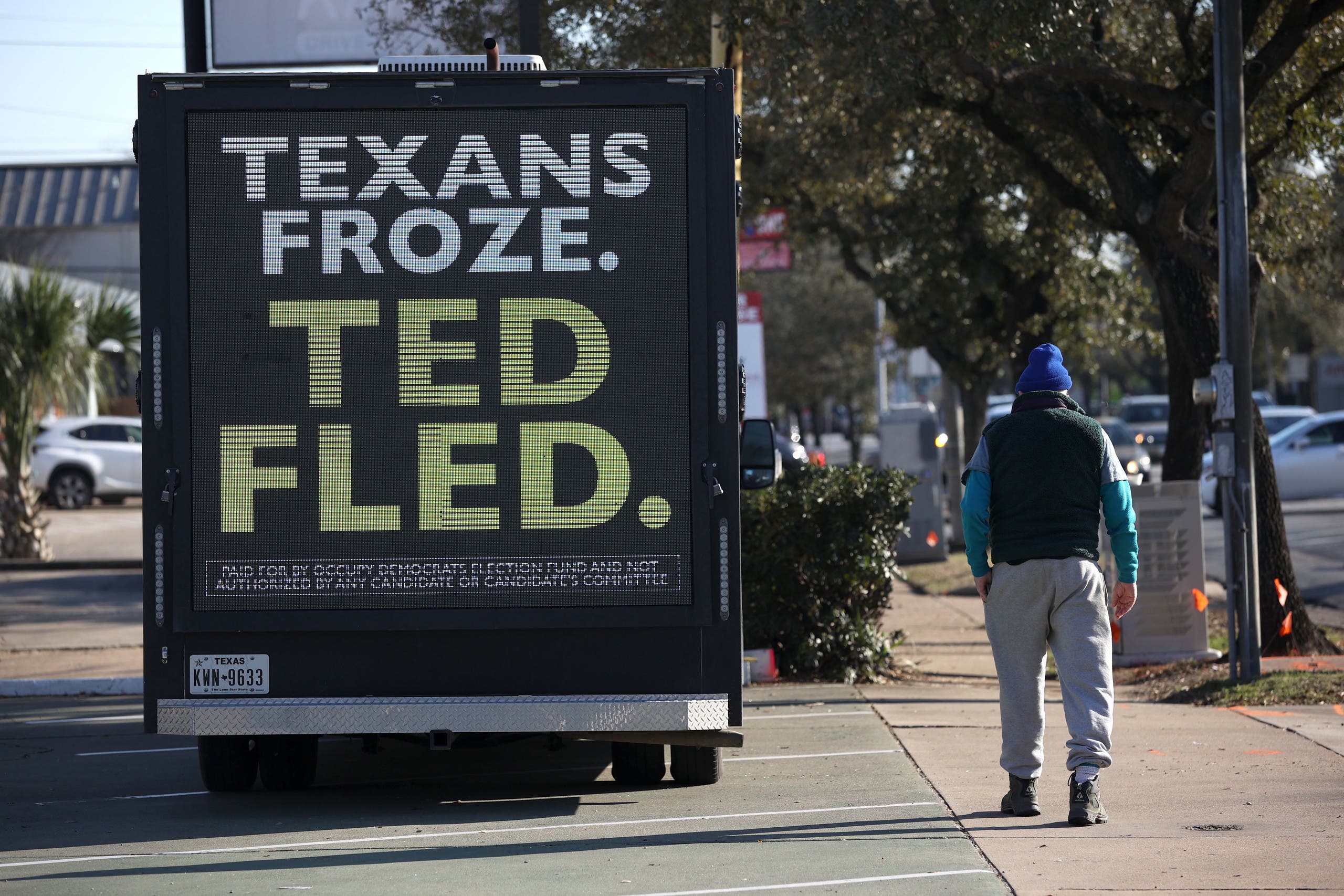 A banner criticizing Senator Ted Cruz as Texans freeze and Ted travels (AFP)