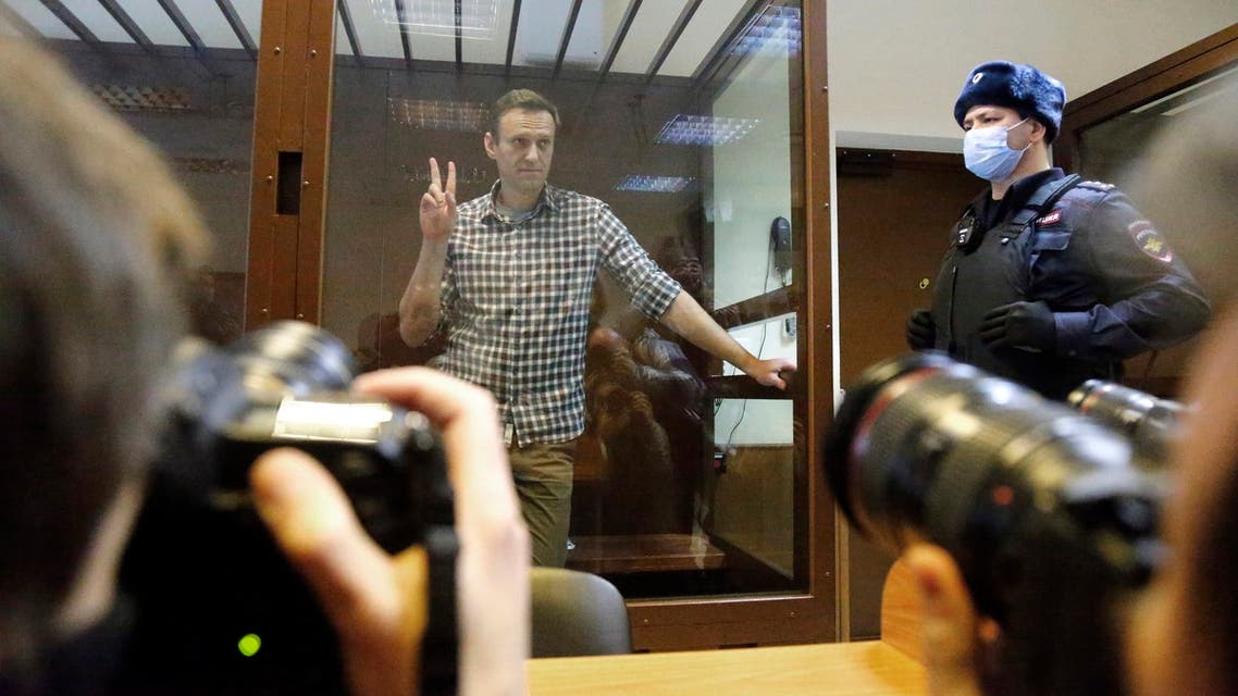 Russian opposition leader Alexei Navalny stands in a cage in the Babuskinsky District Court in Moscow, Russia, Saturday, Feb. 20, 2021. Two trials against Navalny are being held Moscow City Court one considering an appeal against his imprisonment in the embezzlement case and another announcing a verdict in the defamation case. (AP)