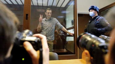  Russian opposition leader Alexei Navalny stands in a cage in the Babuskinsky District Court in Moscow, Russia, Saturday, Feb. 20, 2021. Two trials against Navalny are being held Moscow City Court one considering an appeal against his imprisonment in the embezzlement case and another announcing a verdict in the defamation case. (AP)