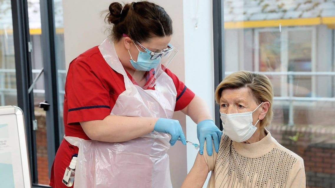 Annie Lynch (R), the first person to receive the Pfizer BioNTech Covid-19 vaccine in Ireland receives her second dose of the vaccine from vaccinator Deborah Cross (L) at St James’s Hospital in Dublin on January 19, 2021. (Marc O'Sullivan/Pool/AFP)