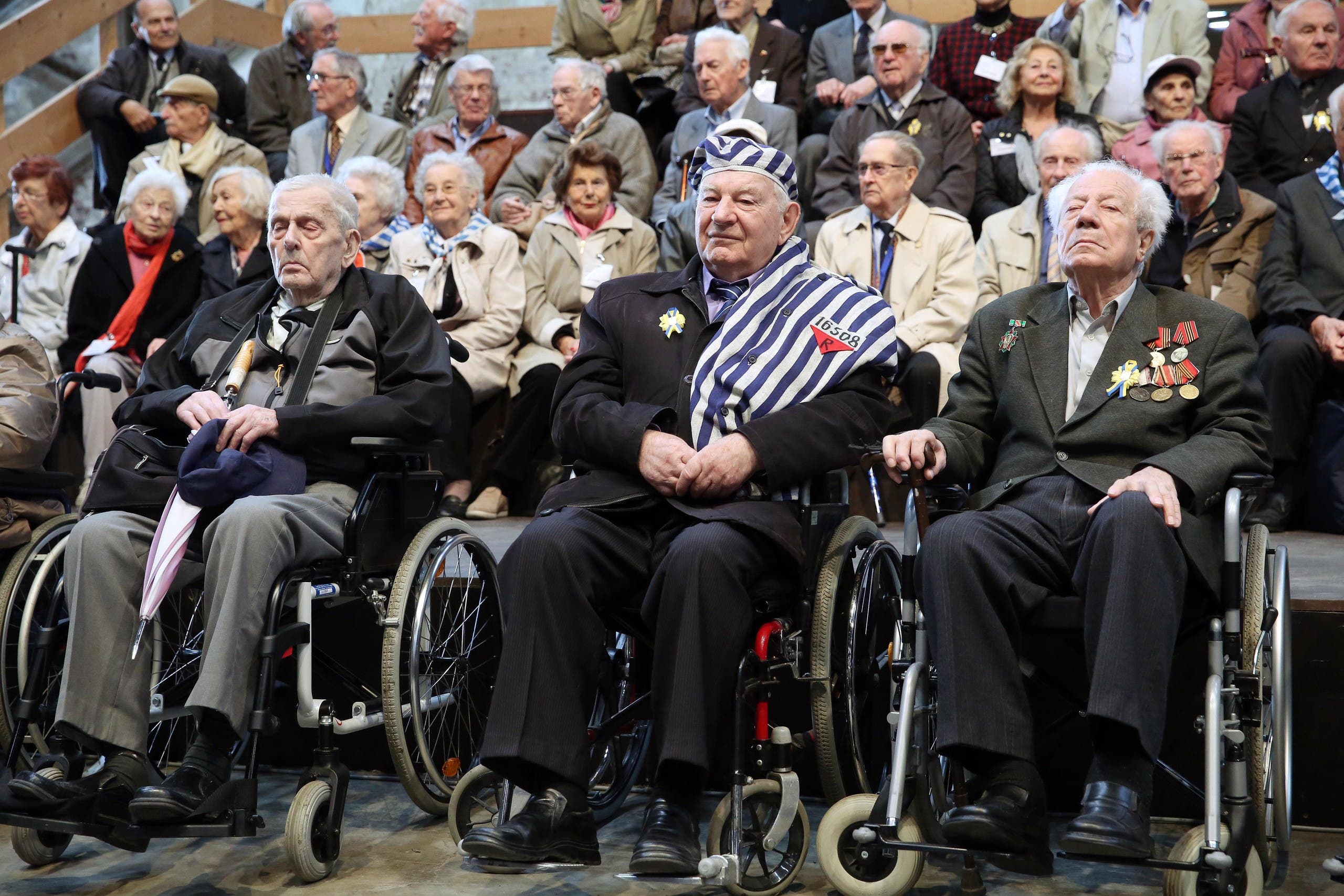 Survivors of the former Nazi concentration camp Neuengamme take part in the memorial service commemorating the 70th anniversary of the liberation of Neuengamme in Hamburg, Germany, Monday, May 4, 2015. (AP)