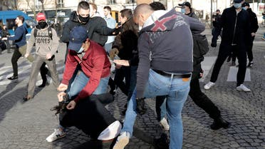  Supporters of the movement Generation Identity clash with an anti fascist activist, on the pavement, during a demonstration Saturday, February 20, 2021 in Paris. (AP)