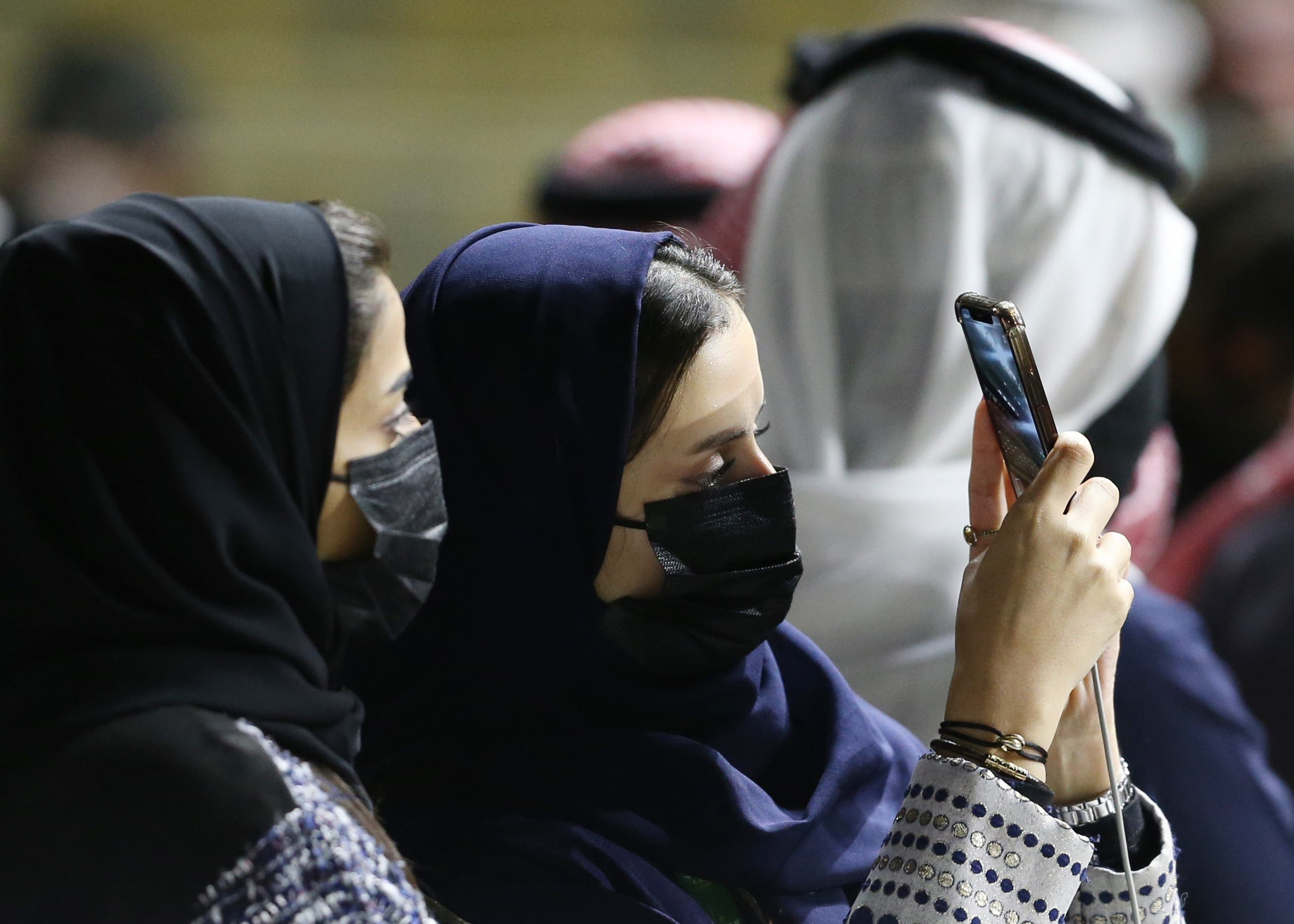 Spectators at the racetrack take a selfie. (Reuters)