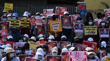 Protesters hold up signs during a demonstration against the military coup in Yangon on February 20, 2021. (File photo: AFP)