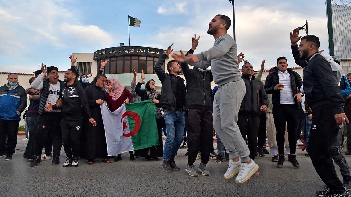 Algerians gather outside the Kolea prison, west of the capital Algiers, on February 19, 2021, after the announcement that a dozen pro-democracy activists are set to be released. (Ryad Kramdi/AFP)