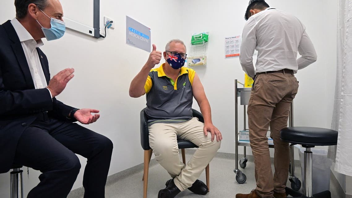 Australia's Prime Minister Scott Morrison reacts after receiving a dose of the Pfizer/BioNTech Covid-19 vaccine, as Minister for Health Greg Hunt (L) looks on, at the Castle Hill Medical Centre in Sydney on February 21, 2021.