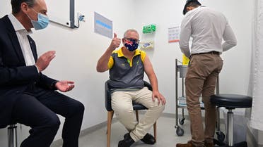 Australia's Prime Minister Scott Morrison reacts after receiving a dose of the Pfizer/BioNTech Covid-19 vaccine, as Minister for Health Greg Hunt (L) looks on, at the Castle Hill Medical Centre in Sydney on February 21, 2021.