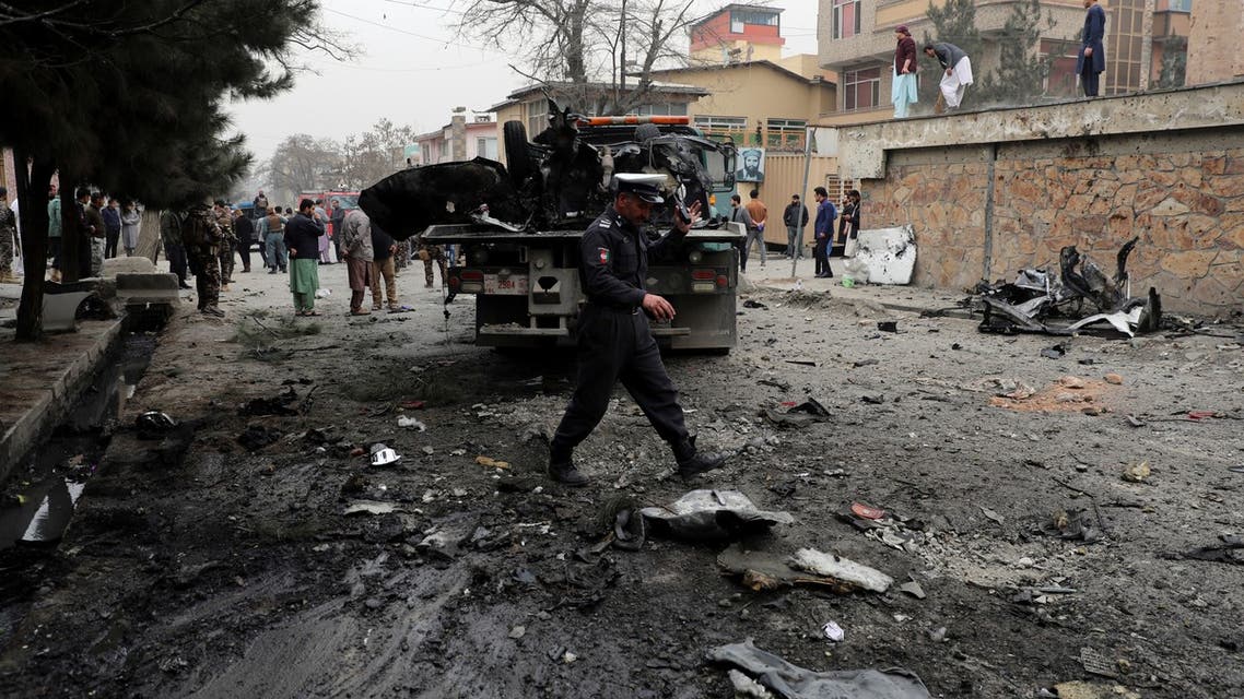 Security personnel inspect the site of a bomb attack in Kabul, Afghanistan, Saturday, Feb. 20, 2021. Three separate explosions in the capital Kabul on Saturday killed and wounded numerous people an Afghan official said. (AP Photo/Rahmat Gul)