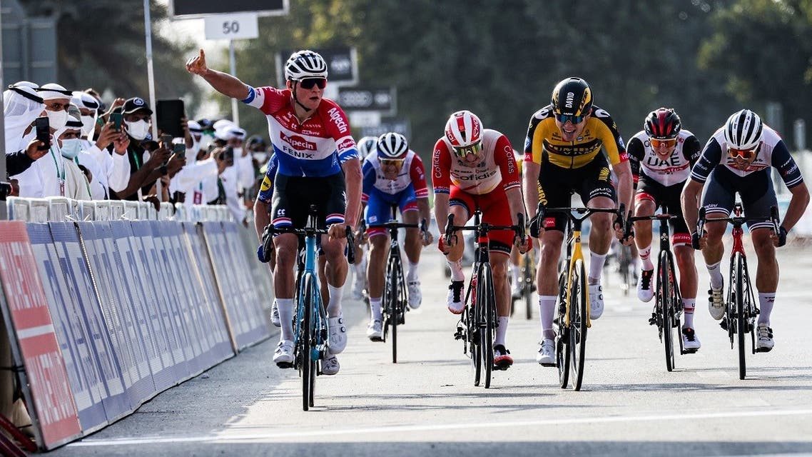 Dutch cyclist Mathieu van der Poel (L) of Team Alpecin–Fenix gestures as he approaches the finish line to win the first stage of the UAE Cycling Tour from al-Dhafra Castle to al-Mirfa on February 21, 2021. (Giuseppe Cacace/AFP)