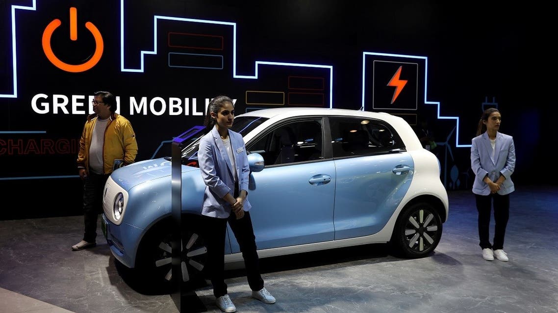 Models pose next to Great Wall Motors (GWM) GWM R1 electric car at its pavilion at the India Auto Expo 2020 in Greater Noida, India, on February 5, 2020. (Reuters)