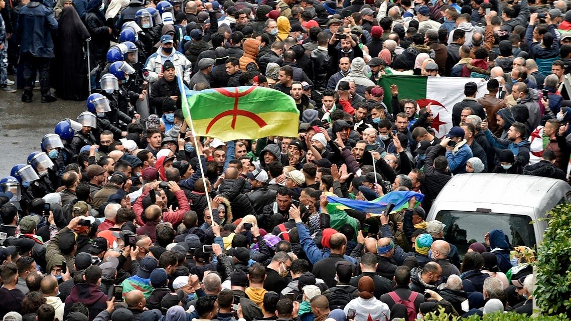 Algerians rally in the capital Algiers on February 22, 2021, marking the second anniversary of the country’s anti-government “Hirak” protest movement. (Ryad Kramdi/AFP)