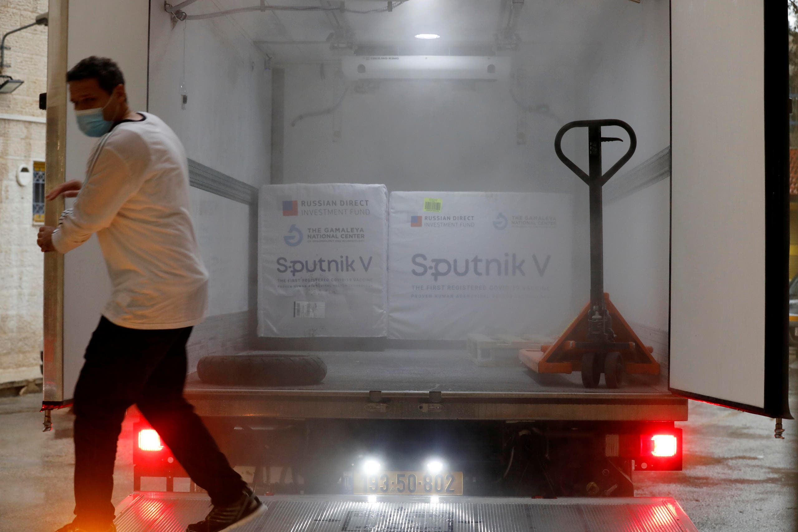 A Palestinian worker prepares to unload a shipment of Russia's Sputnik V vaccine amid the coronavirus disease (COVID-19) outbreak, in Ramallah. (Reuters)