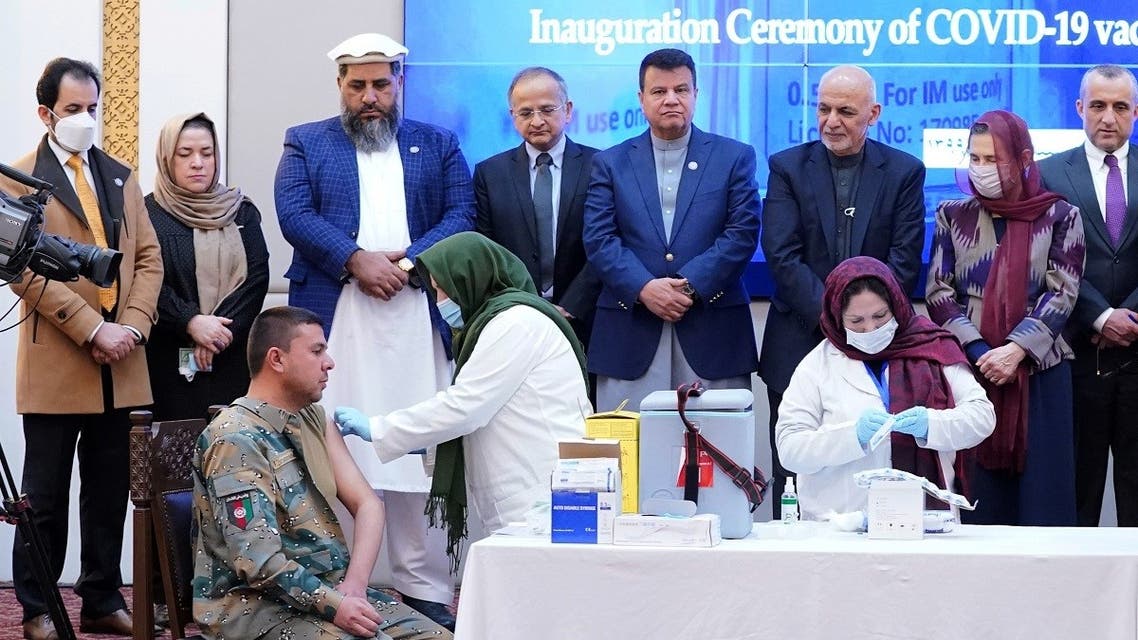 Members of Afghan security forces receive the first dose of AstraZeneca's COVID-19 vaccine from India, during a ceremony at the presidential palace in Kabul, Afghanistan, on February 23, 2021. (Reuters)