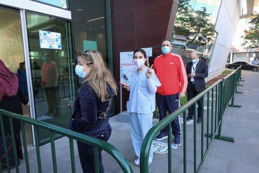 People queue to receive the COVID-19 Pfizer/BioNTech vaccine at Lebanon’s American University Medical Center in the capital Beirut, on February 14, 2021. (File photo: AFP)