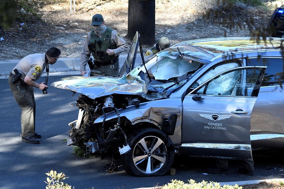 Los Angeles County Sheriff's Deputies inspect the vehicle of golfer Tiger Woods, who was rushed to hospital after suffering multiple injuries, after it was involved in a single-vehicle accident in Los Angeles, California, US, on February 23, 2021. (Reuters)