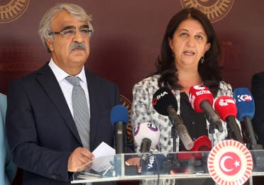Co-chairmans of the pro-Kurdish Peoples’ Democratic Party (HDP) Pervin Buldan (R) and Mithat Sancar (L) hold a press conference following the arrest of 82 people, including members of their party, outside the Parliament building, Ankara, October 1, 2020. (Adem Altan/AFP)
