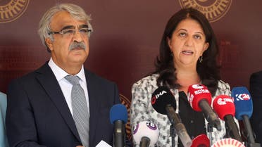 Co-chairmans of the pro-Kurdish Peoples’ Democratic Party (HDP) Pervin Buldan (R) and Mithat Sancar (L) hold a press conference with their members as they boycott the first sessiom of the Grand National Assembly’s 27th term following the arrest of 82 people, including members of their party, outside the Parliament building in Ankara on October 1, 2020. (Adem Altan/AFP)