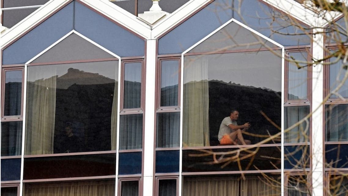 A man sits at a window of the Radisson Blu hotel at Heathrow Airport in west London on February 17, 2021 where travellers are undertaking mandatory hotel quarantine because of the coronavirus pandemic. (AFP)