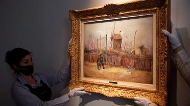 Sotheby’s personnel display ‘Scene de rue à Montmartre’ (Street scene in Montmartre), a painting by Dutch master Vincent van Gogh at Sotheby’s auction house in Paris, on February 25, 2021. (AP)